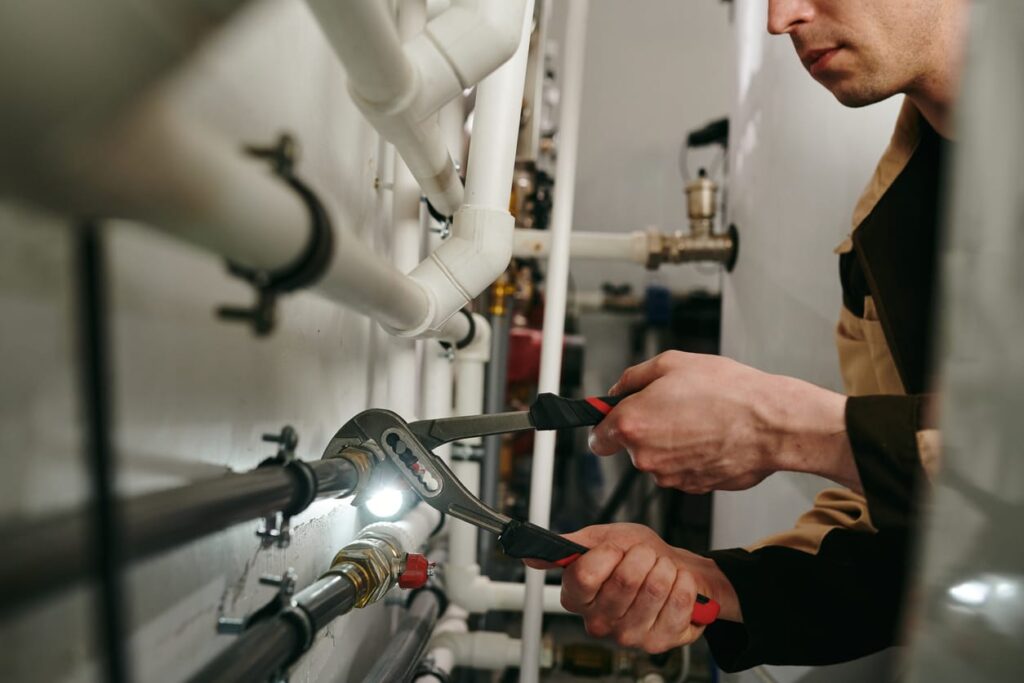 Plumbers maintaining commercial plumbing pipes in Chandler
