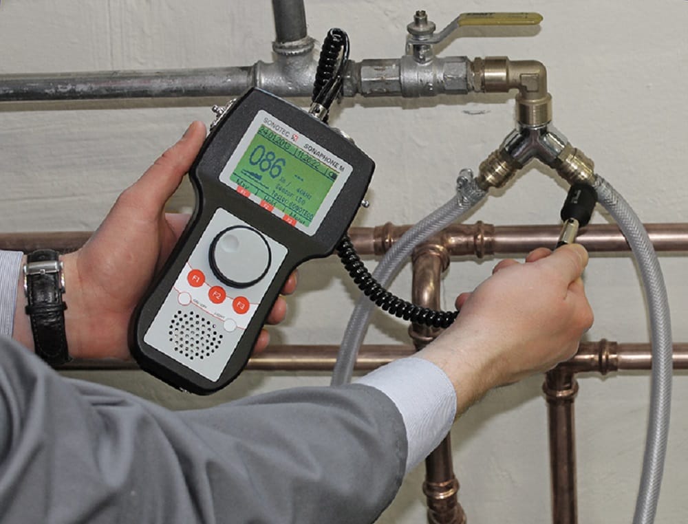 Plumber testing pipes with electronic leak detection equipment in Chandler