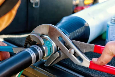 Technician tightening an industrial pipe connection in Chandler