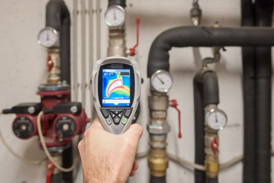 Plumber using a thermal imaging camera to inspect pipes in Chandler