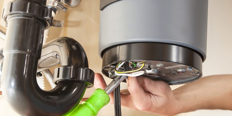 Technician repairing the heating element of a water heater in Chandler