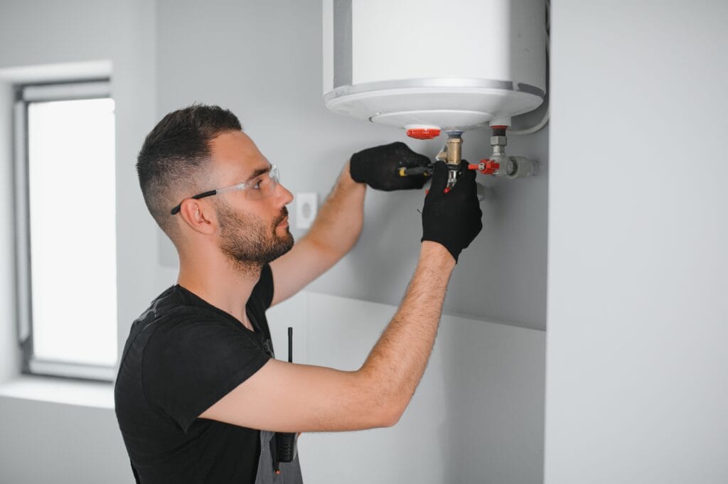 Technician performing water heater maintenance in Chandler