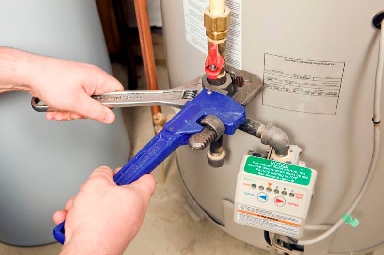 Plumber repairing a water heater valve in Chandler